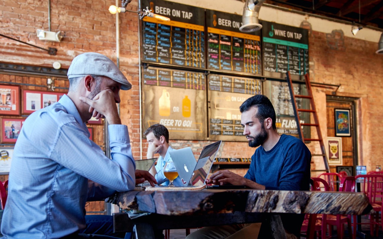 Multiple people working from a cafe