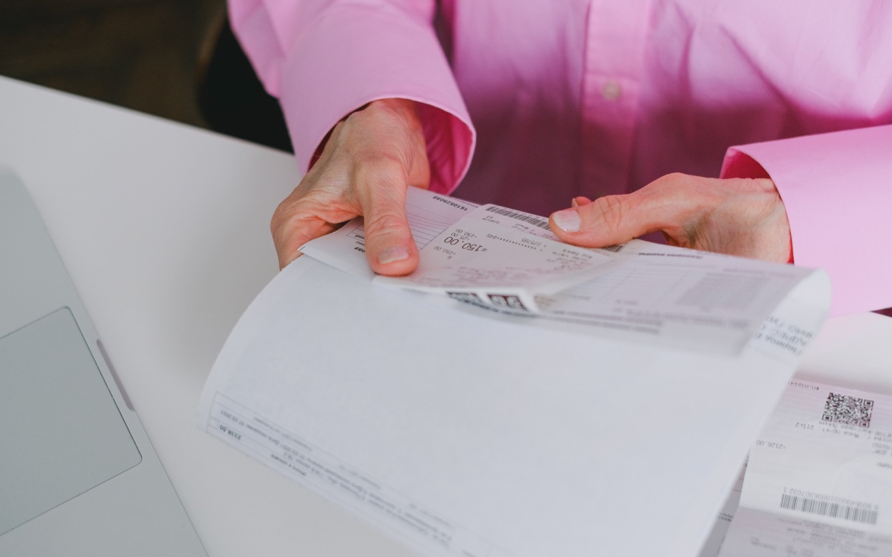 A man checking a receipt he has received