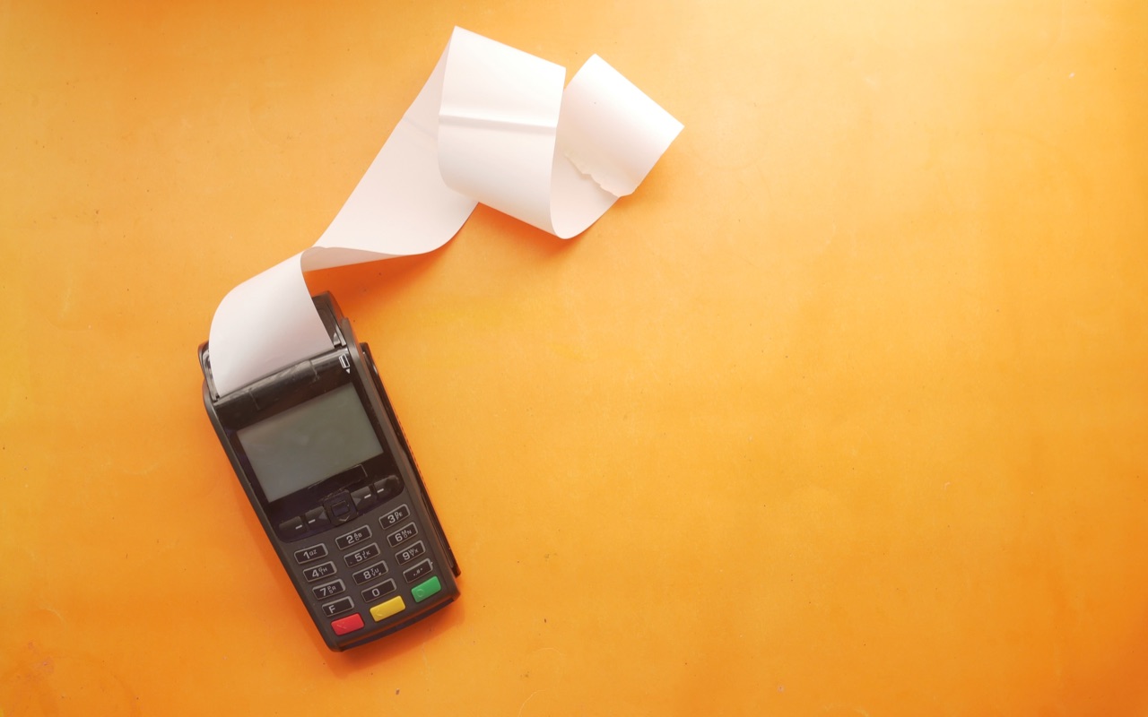 A payment terminal with an empty receipt