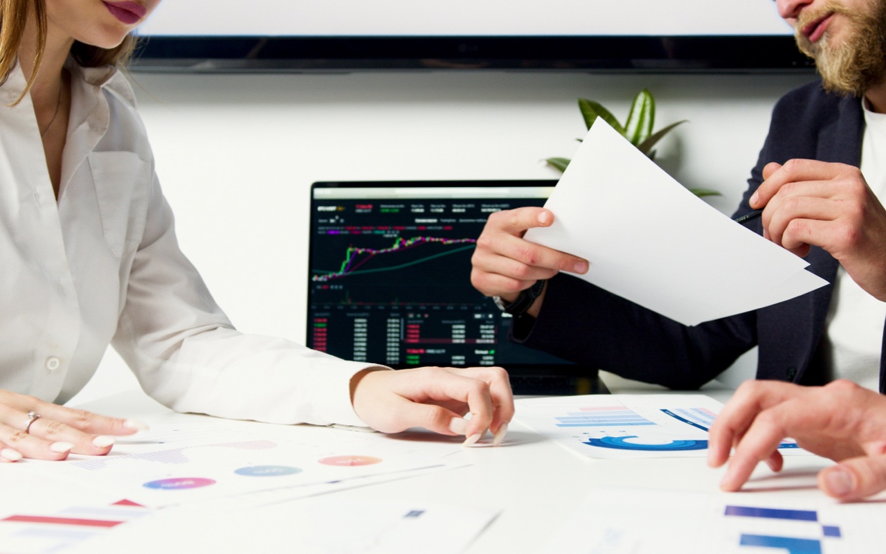 A man and a woman discussing an investment decision