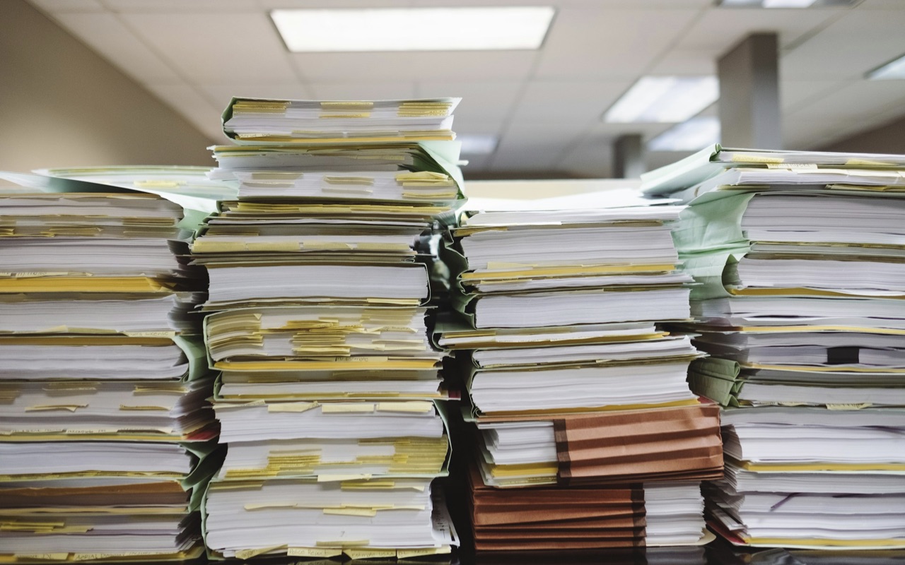 A pile of folders containing invoices