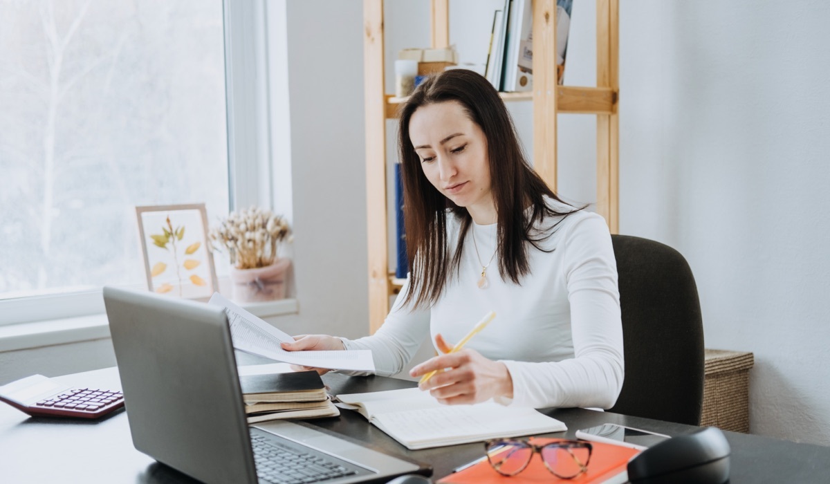 An accountant at her desk, processing accounts payable of a business.